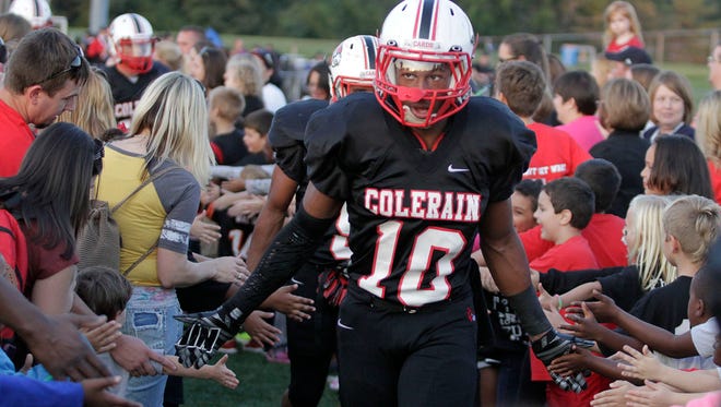 Amir Riep of Colerain makes his way through a tunnel on the field to support the Cardinals.