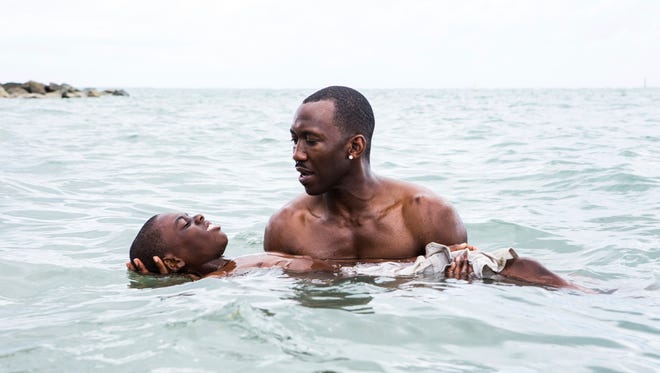 This image released by A24 Films shows Alex Hibbert, left, and Mahershala Ali in a scene from the film, "Moonlight."  (David Bornfriend/A24 via AP)