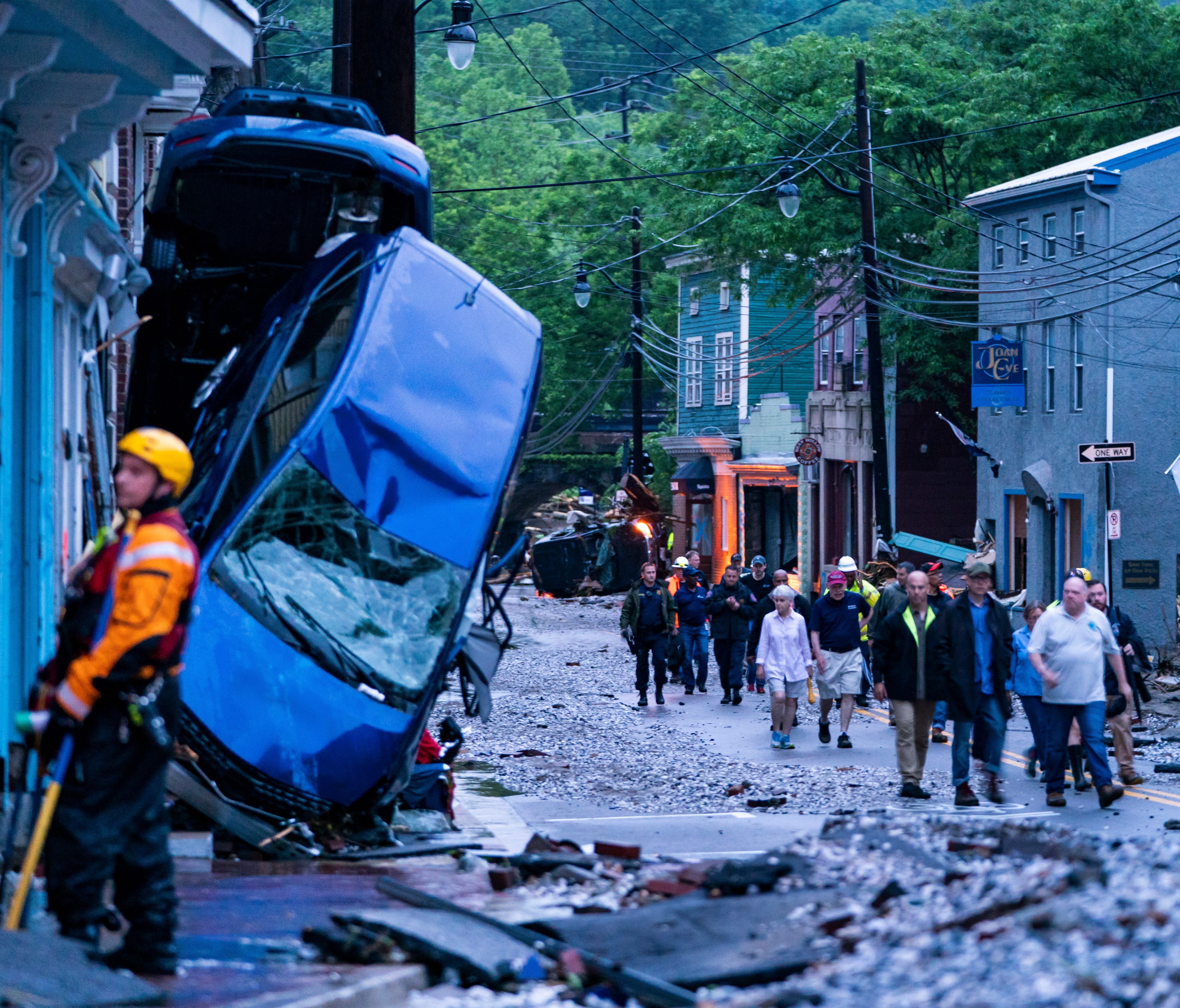 Rescue personnel examine damage on Main Street after a flash flood rushed through the historic town of Ellicott City, Maryland, on May 27, 2018.