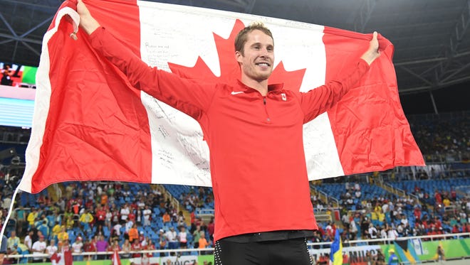 Aug 16, 2016; Rio de Janeiro, Brazil; Derek Drouin (CAN) wins gold during the men's high jump final in track and field competition in the Rio 2016 Summer Olympic Games at Estadio Olimpico Joao Havelange. Mandatory Credit: Kirby Lee-USA TODAY Sports