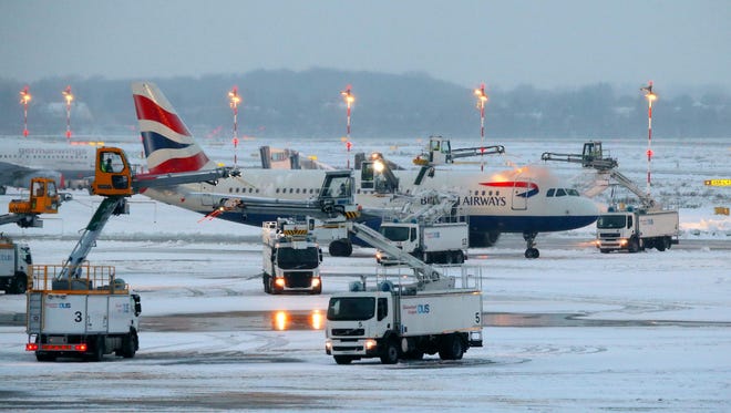 A British Airways jet is being de-iced at the airport in Dusseldorf, Germany, on Dec. 10, 2017. Due to the weather conditions, Duesseldorf airport was forced to close for four hours during the afternoon, news agency DPA reported.