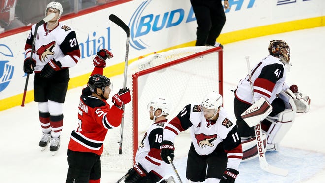 New Jersey Devils defenseman Adam Larsson (5), of Sweden, celebrates after scoring the game-winning goal against the Arizona Coyotes during overtime of an NHL hockey game, Tuesday, Oct. 20, 2015, in Newark, N.J. The Devils won 3-2 in overtime.
