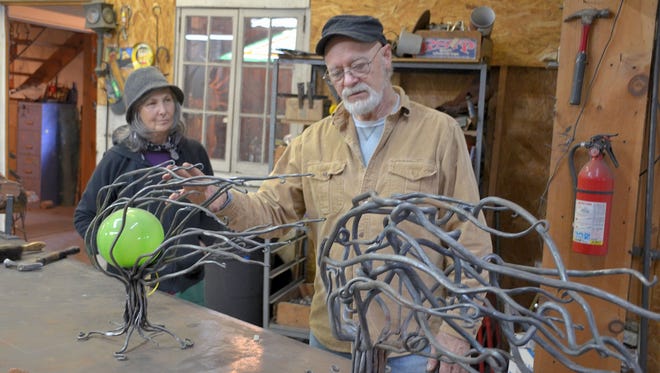 Dan and Tekla Howachyn behold Dan's abstract burning bush sculpture in their studio.