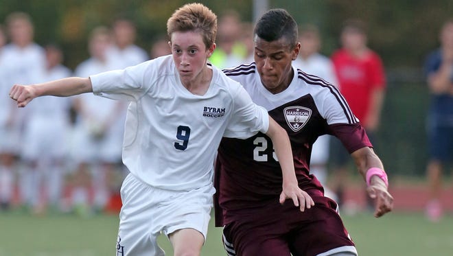 Ryan Noel (9) of Byram Hills and Harrison's Gabe Ferrierra (25) battle for control of the ball during boys soccer game at Byram Hills High School in Armonk Oct. 17, 2016. Byram Hills defeats Harrison 3-1. 