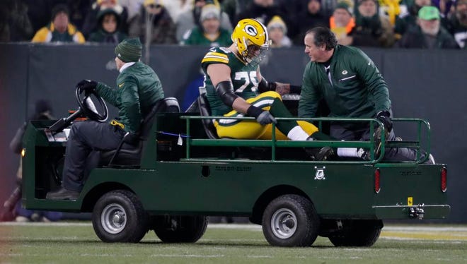 Green Bay Packers offensive tackle Jason Spriggs (78) leaves the field after getting injured against the Vikings Saturday, December 23, 2017, at Lambeau Field in Green Bay, Wis.