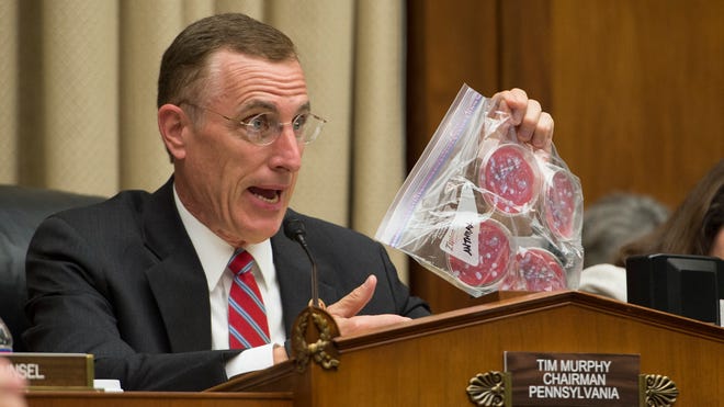 Rep. Tim Murphy, R-Pa., chairman of the House Energy and Commerce Subcommittee, holds up a Ziploc bag as an example of how pathogenic agents were handled at the Centers for Disease Control.
