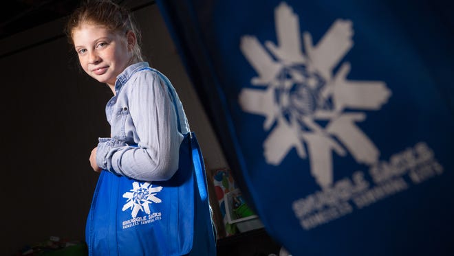 Addyson Goss, of Fenton, Mich. founder of Snuggle Sacks-Homeless Survival Kits stands by supplies she has collected through donations on Thursday February 23, 2017 that she incorporates into the bags containing personal hygiene products as well as snacks and clothing items that she distributes to the homeless. Goss started the company when she was 8 years-old after meeting her grandfather who she found out had been homeless for six of the past ten years.