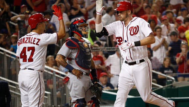 Washington Nationals Matt Wieters (32) is congratulated by teammate Gio Gonzalez (47) while St. Louis Cardinals catcher Yadier Molina (4) watches after hitting a home run during the fourth inning of a baseball game in Washington, Tuesday, April 11, 2017. (AP Photo/Manuel Balce Ceneta)