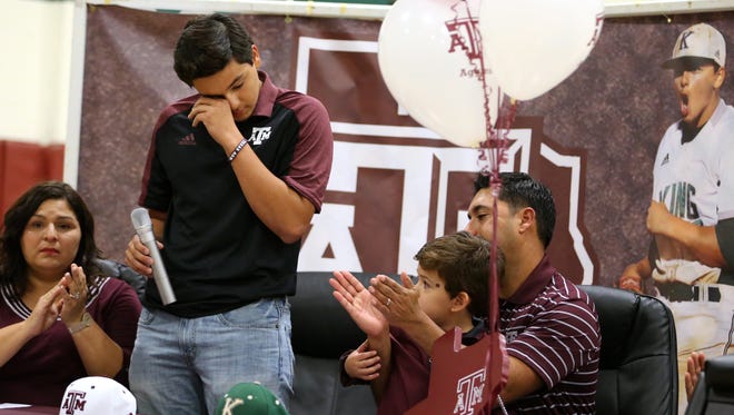 King High School student Dustin Saenz, 17, wipes away a tear after reading an essay while his mother, Marina Saenz, brother, Drew Saenz, 3, and father, Rey Saenz, attend a signing ceremony at the high school on Wednesday, November 9, 2016 at the school. Dustin signed to play at Texas A&M.