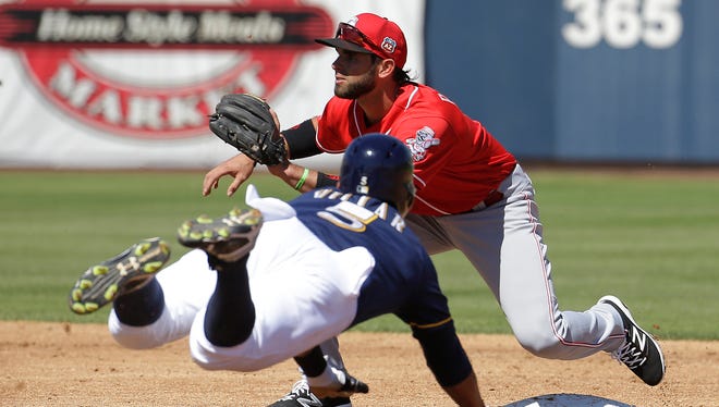 The Reds' Jose Peraza waits for the throw as the Brewers' Jonathan Villar dives to second during the second inning of a spring training baseball game on Friday, March 18, 2016, in Phoenix.