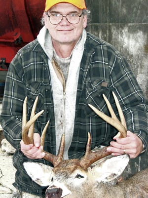 Green Bay Packers Hall of Fame kicker Chester Marcol poses with a buck he shot near Algoma in 2006.