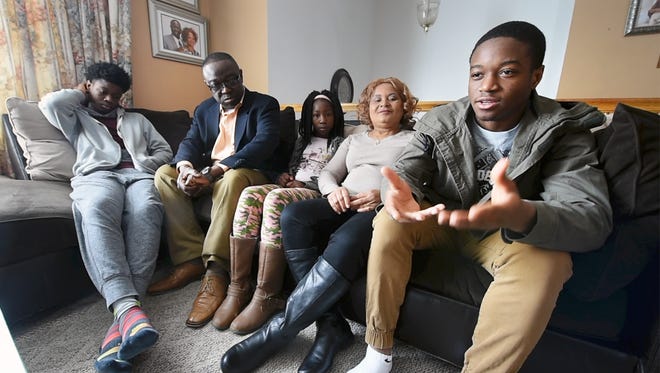 Fred Mulbah, Jr., right talks about a difficult 10th grade year, the same year he decided to take basketball seriously while his family looks on.