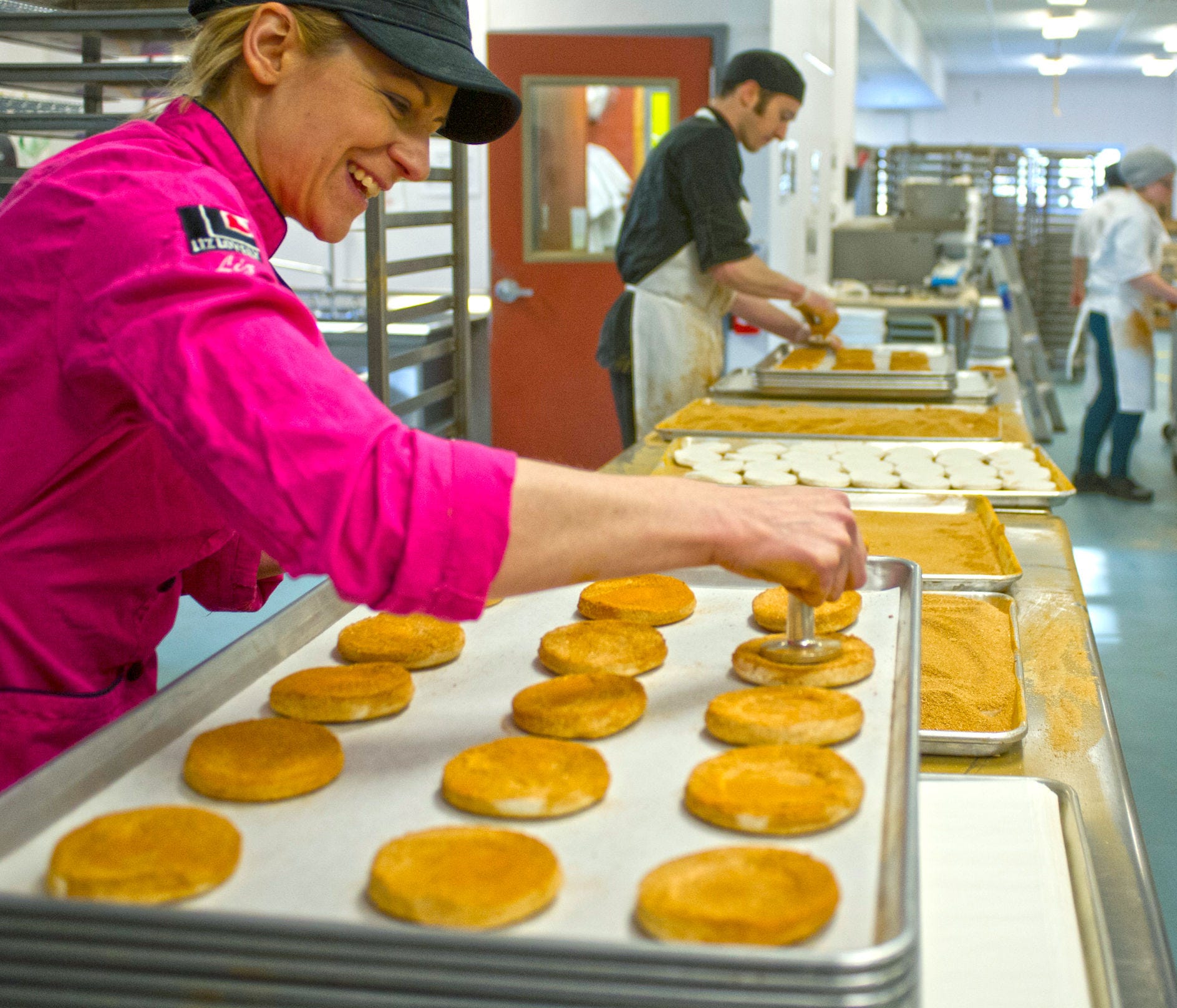 Liz Holtz, owner of Liz Lovely, works on coating cinnamon sugar cookies on the production line at her bakery in Waitsfield on March 19. Liz Lovely specializes in making vegan, gluten-, and GMO-free cookies.