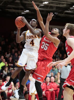 Iona’s Schadrac Casimir shoots while being checked by Marist’s Phillip Lawrence (35) in the first half Sunday at Iona College in New Rochelle. Iona won 89-67.