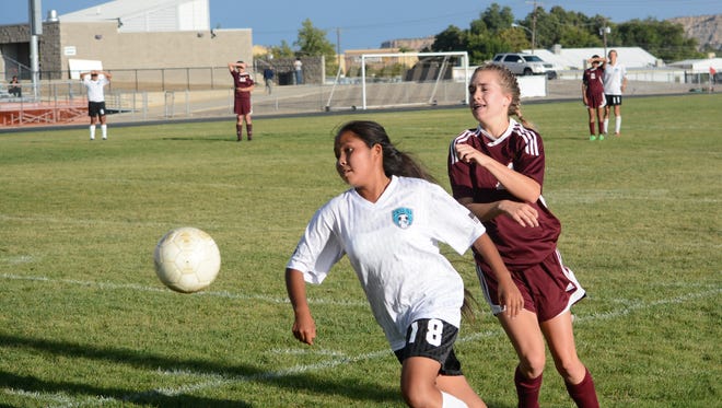 Navajo Prep's Shaynia Jackson goes after the ball with Rehoboth Christian's Maddie Arsenault tailing her during a district match on Sept. 26 in Farmington. Prep opens the 2018 season at the Taos Invitational on Aug. 24.