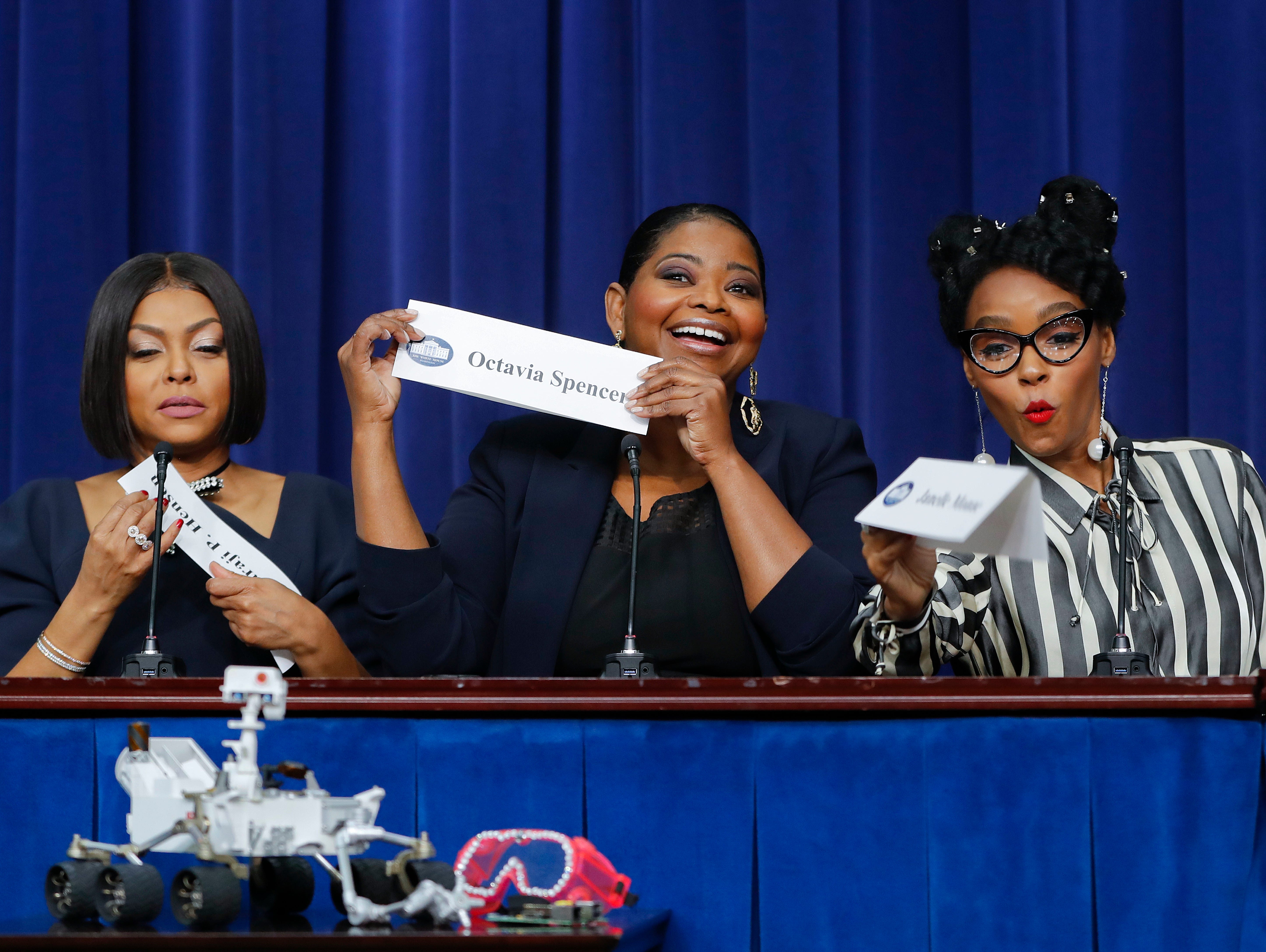 Actresses Taraji P. Henson, Octavia Spencer, and Janelle Monae snap-up their name plaques after the screening of the movie 'Hidden Figures.'