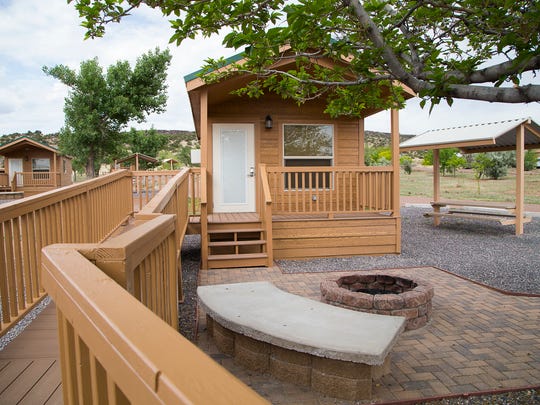 Each Lyman Lake camping cabin has a view of the lake and comes with a covered porch, bunk beds with mattresses, table, chairs, heat and air conditioning.