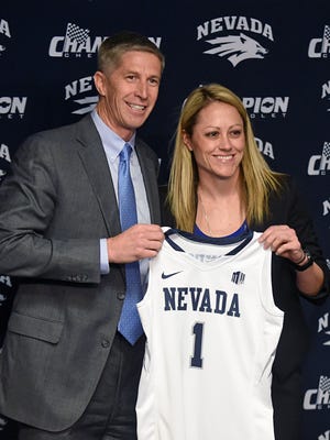 Nevada athletic director Doug Knuth presents Amanda Levens with a Wolf Pack jersey as she is introduced as the school's new women's basketball coach Wednesday.