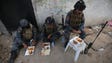 Iraqi security forces have lunch as they hold a position