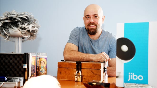 Nicholas Altman, owner of the new coffee shop, Fractals, which opens March 15, with a few of the shop's oddities, including a robot and a lock box with locks to pick.