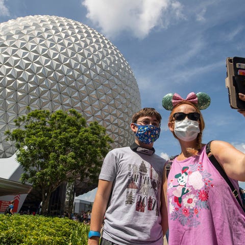 Visitors in masks at Epcot Center in Disney World.