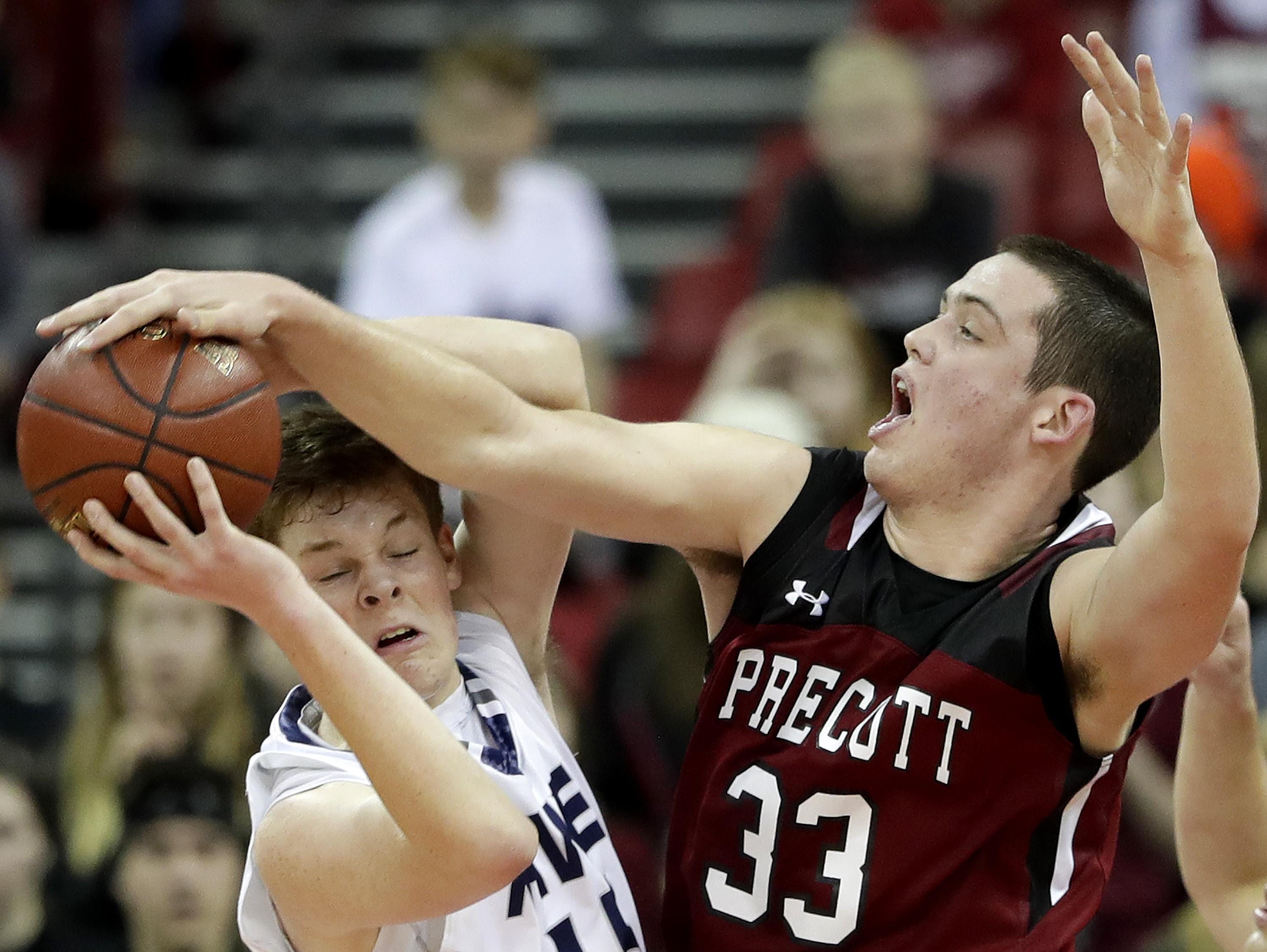 Xavier’s Nate DeYoung, left, has a shot blocked by Owen Hamilton during Saturday’s game in Madison.