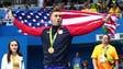 Anthony Ervin celebrates with his gold medal in the