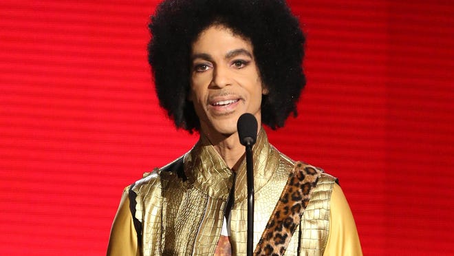 In this Nov. 22 file photo, Prince presents an award at the American Music Awards in Los Angeles. On the front lines of America’s fight against a drug-abuse epidemic, there have been emotional, sometimes contradictory reactions to news that investigators are looking into whether Prince died of an overdose.