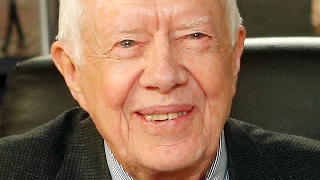 Former US President Jimmy Carter poses for a photo as he promotes his new book "A Call To Action Women, Religion, Violence, And Power" at Barnes & Noble, 5th Avenue on March 25, 2014, in New York City.