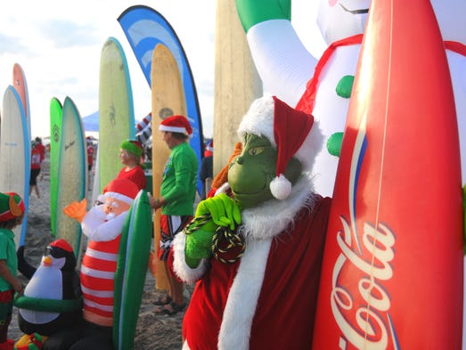 Thousands turned out to watch hundreds of surfing Santas