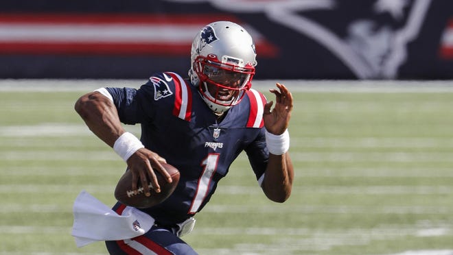 New England Patriots quarterback Cam Newton scrambles against the Miami Dolphins during an NFL football game at Gillette Stadium, Sunday, Sept. 13, 2020 in Foxboro.