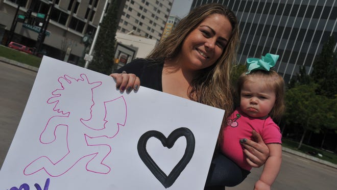 Tara Johnston, 29, holds her daughter at a Reno rally on Saturday, Sept. 16, 2017 to show solidarity with the main march in D.C. against the FBI's distinction of Juggalos as gang members.