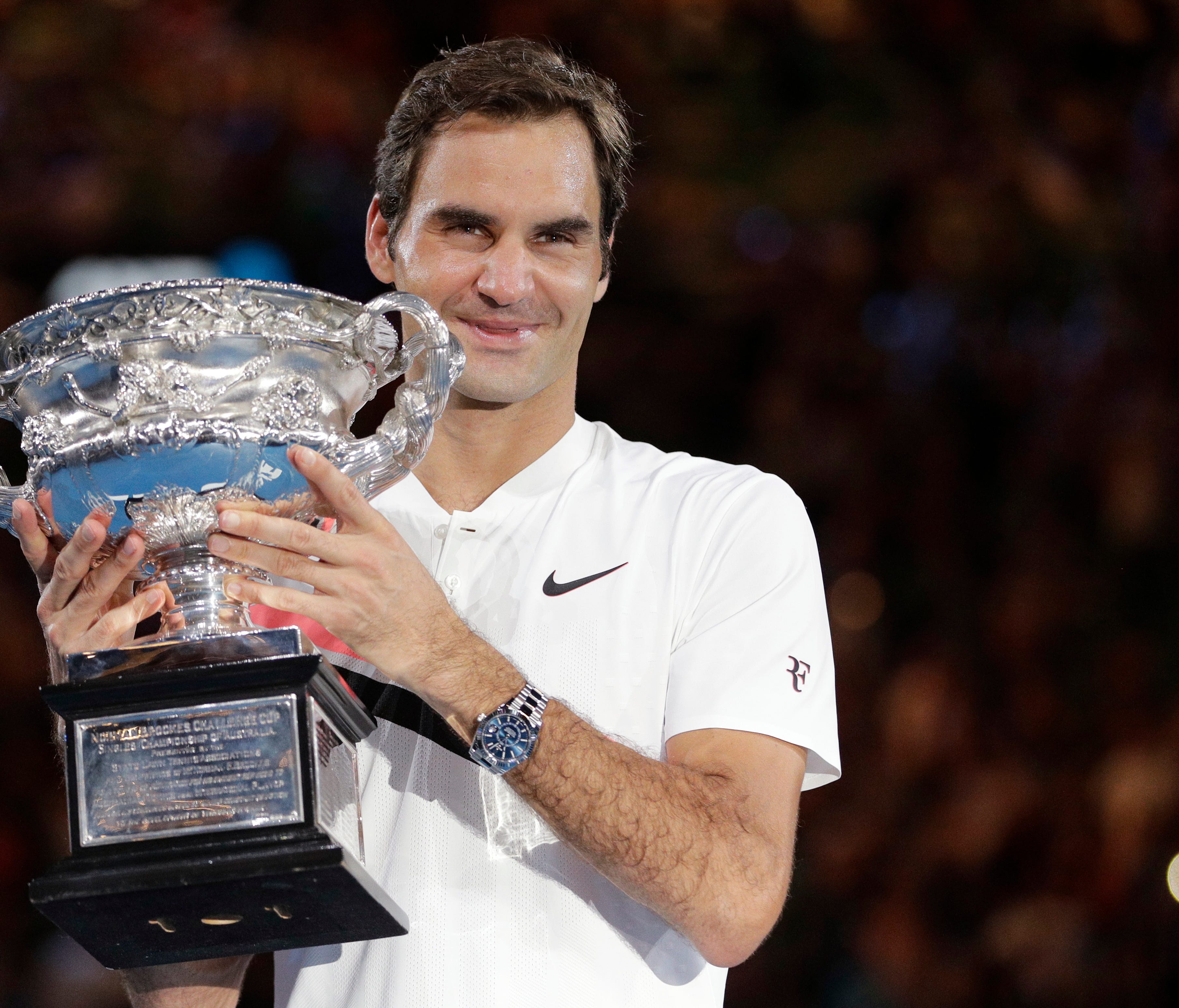 Roger Federer holds the trophy after winning the Australian Open on Sunday.