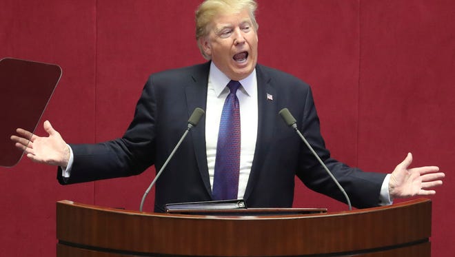 President Trump is pictured delivering a speech at the National Assembly in Seoul.