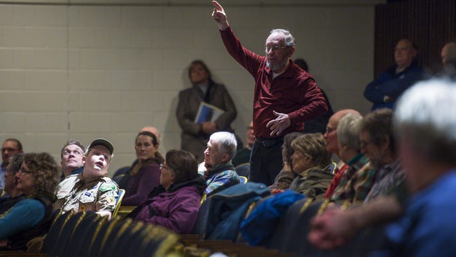 Bob Magoon speaks in favor of a bond to renovate the Colchester High School auditorium during Colchester Town Meeting on Monday, February 29, 2016.
