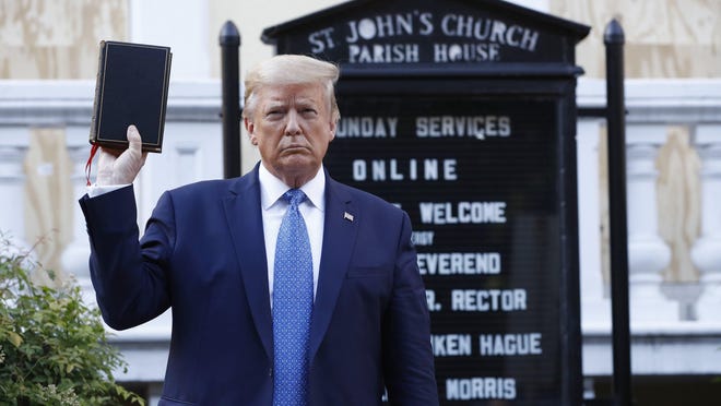 President Donald Trump holds a Bible as he visits outside St. John's Episcopal Church in Washington on Monday.
