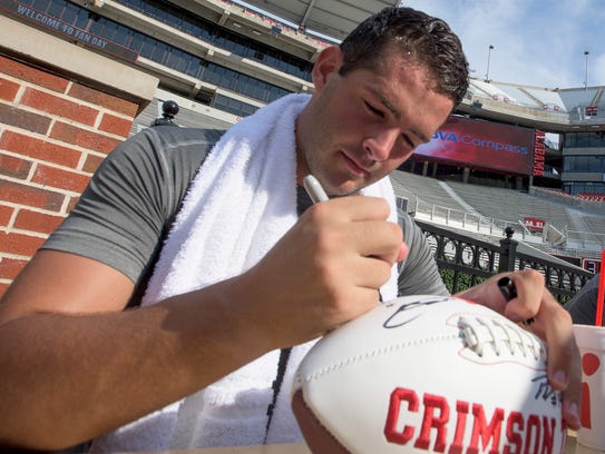 Alabama kicker Andy Pappanastos (92) signs autographs