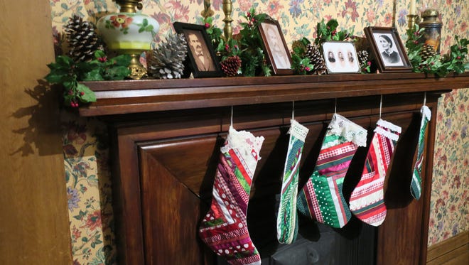 Stockings hang at a fireplace in the Wisner Mansion.