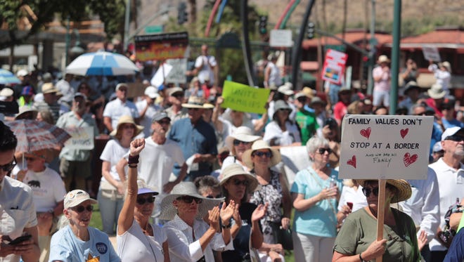 Hundreds of people attend Saturday's Keep Families Together rally at Frances Stevens Park along North Palm Canyon Drive in Palm Springs.