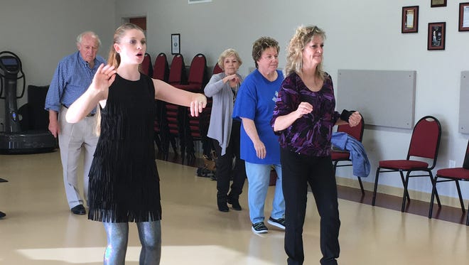 KayLeigh Berenzy (front left) and Dena Richardson (front right) lead the rest of the class through some of the basic steps in the Rumba.