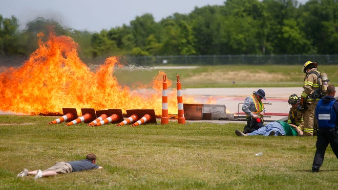 Firefighters and paramedics tend to actors portraying airplane crash victims during a disaster drill at the Springfield-Branson National Airport on Wednesday.