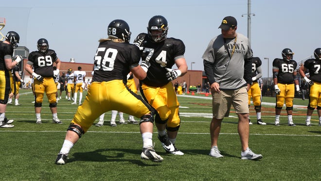 Offensive line coach Brian Ferentz, right, oversees a drill at last year's open practice at Valley Stadium. Friday will mark the fourth straight year that the Hawkeyes have come to West Des Moines for a spring practice.