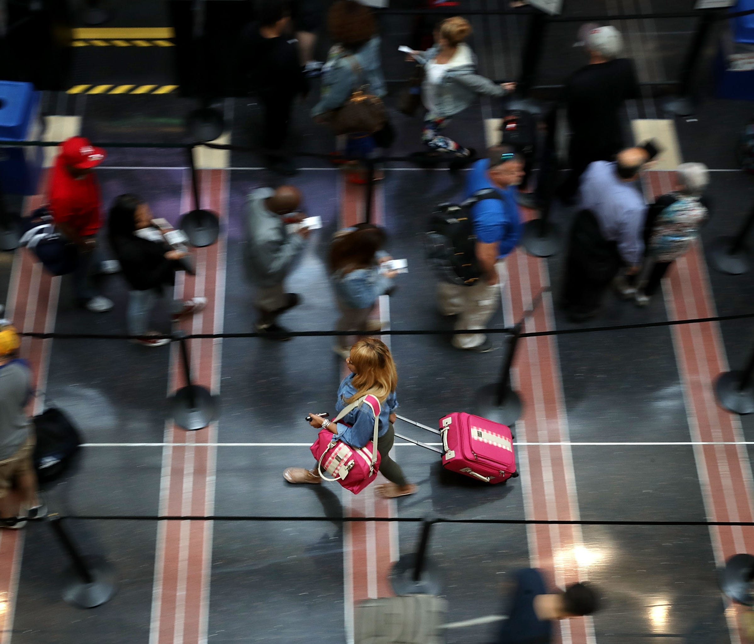 Travelers move through a   Transportation Security Administration line at Ronald Reagan National Airport on Sept. 1, 2017