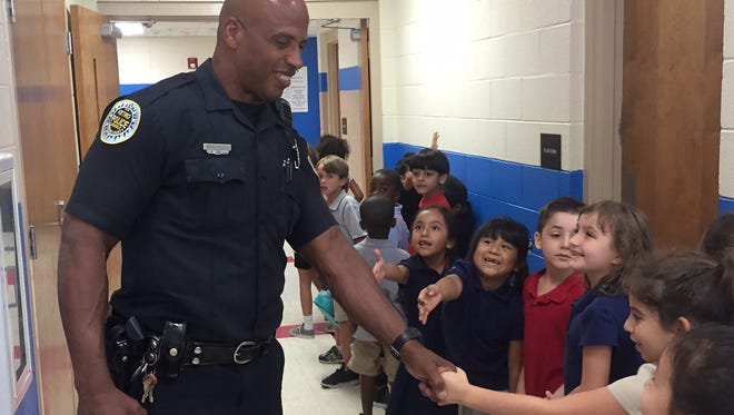 Metro Police Officer Steve Turner greets students at Maxwell Elementary School on Friday, Sept. 9, 2016 during a luncheon in honor of first responders for 9/11.