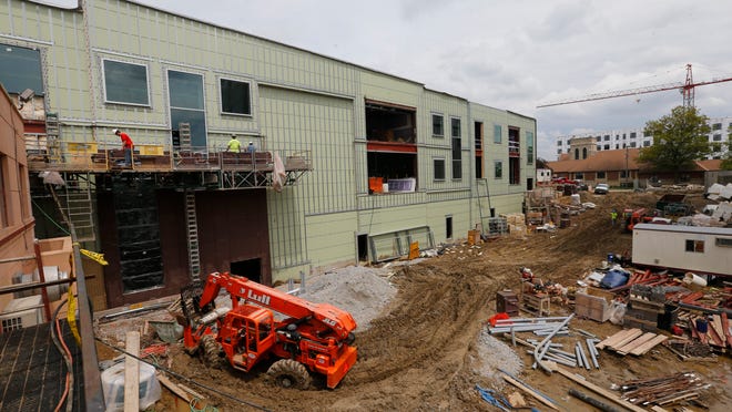 Construction is underway on a new mixed-use building owned by Kingland Systems near Lincoln Way and Welch Avenue on Wednesday. The project is one of several development reshaping Ames’ Campustown area.