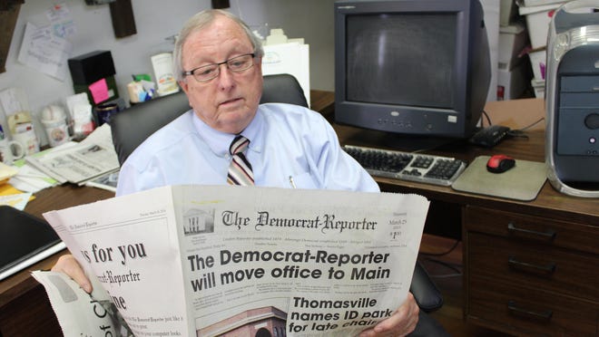 Democrat-Reporter Publisher Goodloe Sutton reviews an article about the paper moving to a new location.