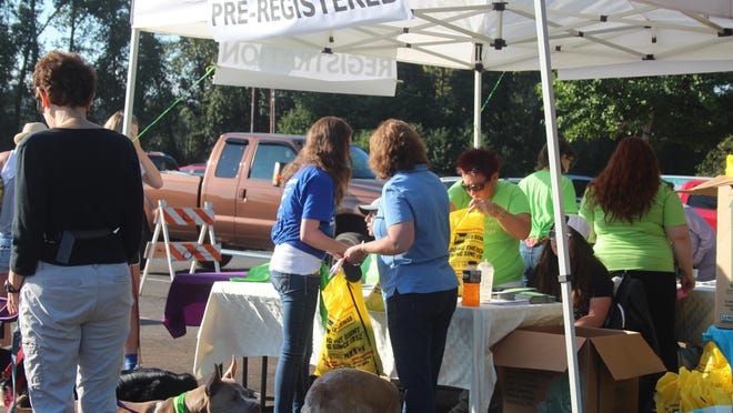A volunteer registers Walk-n-Wag participants at a previous fundraiser.