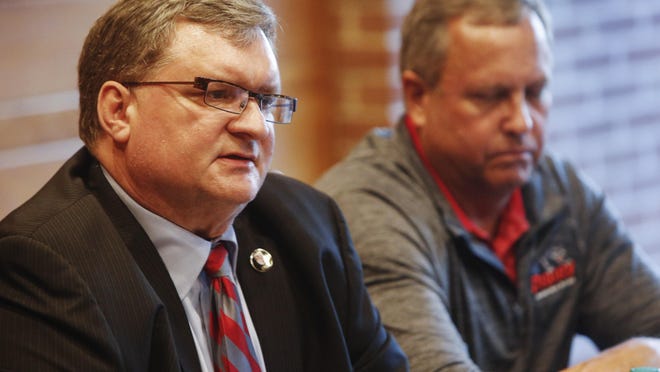Drury University president Tim Cloyd, left, speaks during a press conference regarding the formation of a committee to address hazing in college athletics on Monday. Also pictured is swimming coach Brian Reynolds.