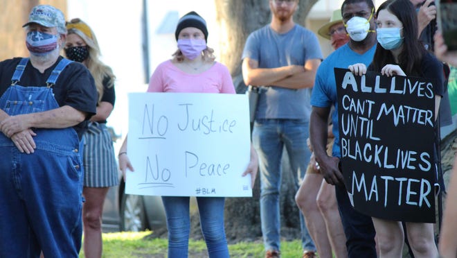Glen Rose High School student Kristeena Gregory (center, holding sign) was among the crowd gathered on the courthouse square Saturday night in Glen Rose that was to billed by adult organizers as "a memorial to Black lives lost to police brutality." The memorial was originally Gregory's idea.