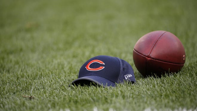 The Chicago Bears cap and the game ball are seen on the field before an NFL football game between the Chicago Bears and the Cleveland Browns, Thursday, Aug. 31, 2017, in Chicago.
